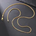 Detailed close-up of golden textured link chain with secure lobster clasp on grey surface - Textured Round Link Chain