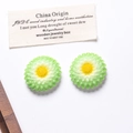Detailed view of green and white gradient resin daisies with bright yellow stamens - Large / Green