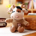 Adorable cow plush toy wearing a cozy brown knitted sweater sitting in a warm home setting. - 30cm / Brown Sweater Style