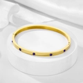 Detailed macro view of 4mm gold plated stainless steel bracelet with blue zircon inlay - 4mm / Gold-Blue Zirconia