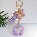 Purple glitter resin letter O keychain with golden butterfly and stylish tassel - Letter O
