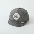 Macro view of grey infant baseball cap with soft suede fabric and Lucky bear patch - Bear / Gray