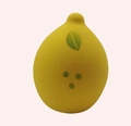 Macro shot of a lemon-shaped yellow makeup sponge with green leaf details and soft texture - Printed Lemon