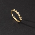 Detailed macro view of heart-shaped gold ring featuring delicate cubic zirconia pave setting - Gold Heart Link Row Rhinestone