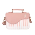 Close-up of piano note embroidery and metal strap buckle on pink and white PU crossbody bag - Pink