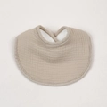 Close-up of cotton crepe baby bib with warm plush lining and absorbent texture in beige - New Khaki