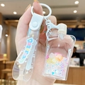 Pink floral quicksand keychain with transparent liquid strap and floating glitter charms - Jelly Squeezer - White