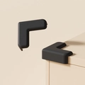 Paraspigoli a L in silicone nero per la protezione dei mobili e la sicurezza dei bambini - Forma a L Nero