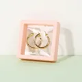 Golden round hoop earrings displayed in a protective pink 3D floating frame box - 7x7x2cm / Pink