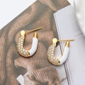Elegant U-shaped gold earrings with sparkling crystals and white enamel finish - White