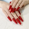 Glossy burgundy red rose patterned coffin press-on nails shown on hand with gold rings - Wine Red Rose Style (JP1033)
