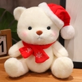 White Christmas teddy bear plush with red hat and snowflake scarf in a cozy setting - Red Scarf Style