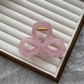 Pink translucent bow-shaped hair claw clip with golden spring on a jewelry tray - 8cm Figure 8 / Jelly Pink