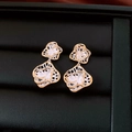 Detailed macro of bicolor gold and silver rose earrings on a black leather jewelry display - Gold-Silver (Hollow Rose Style)