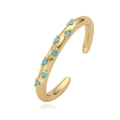 Detail of gold ear cuff featuring a row of seven small round turquoise stones - Gold Turquoise