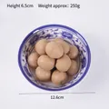 Modelo de albóndigas chinas artificiales realistas en cuenco de porcelana decorativo - Longan