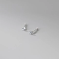 Macro shot of 999 sterling silver four-prong stud earrings with brilliant round zircon - 999 Fine Silver Pair - 2mm White Zirconia