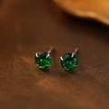 S999 silver stud earrings featuring round-cut green gemstones in a four-claw setting - May Emerald