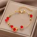French vintage double-layer gold bangle with red beads and floral charms on beige box - Gold Double-line Red Bead Flower Bracelet (G-255)