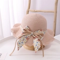 Detail of pink straw sun hat with floral ribbon bow and textured woven pattern - Kids (52-54cm) / Pink Hat