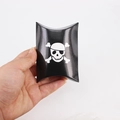 Black Halloween pillow gift box with white skull and crossbones design for candies - Skull Pillow Box