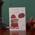 Premium Christmas card with gold-stamped cartoon dog design on rustic wood background - Christmas Puppy Gold Foil