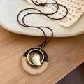 Détail macro du pendentif oiseau avec anneau en bois et corde sur papier vintage - Style Tressé Cercle Oiseau (HN9839-HN9840) / Marron