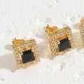 Macro view of gold square stud earrings with black gemstone and sparkling micro-pave crystals - Black
