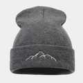 Macro detail of mountain peak embroidery on a thick dark gray knitted beanie hat - Dark Gray
