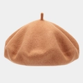 Detailed view of the soft caramel wool felt beret with classic top stem and smooth texture - One Size / Camel