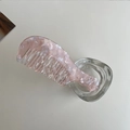Pink marble texture acetate hair comb in a clear glass jar on white table - Sakura Translucent Pink