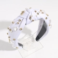 Detailed view of white knotted headband with heart pearls, gold beads and rhinestones - White