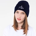 Detailed close-up of GOOD VIBES embroidery on navy blue knitted winter beanie for women - Navy Blue