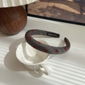 Handmade grey headband with red bow pattern displayed on a white ceramic mug - Grey-Ribbon Bow