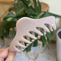 Detail of a large 14cm pink claw clip held against a natural green leaf background - Extra Large (14cm) / Light Nude Pink