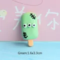 Macro shot of green monster popsicle resin charm with 3 eyes for DIY crafts and 1.6x3.3cm size - Halloween Green Popsicle
