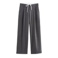 Detail view of dark grey wide leg trousers with a high waist and white drawstring tie - Dark Gray