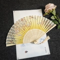 Traditional Chinese folding fan with plum blossom patterns and white silk tassel - Falling Flowers - Yellow