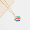 Detailed macro shot of a gold necklace featuring a vibrant rainbow enamel heart pendant - Lake Blue