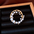 Detailed macro shot of 24k gold plated round pearl brooch on black velvet display - Gold (24K Real Gold Plated)