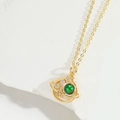 Collana con pendente a pianeta dorato e perla verde su sfondo di marmo bianco puro - Design Pianeta Verde (5599340027137)
