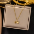 Elegant gold bow pendant necklace with beaded chain displayed on a jewelry box - AH314 Bowknot Pendant Gold