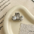 Detailed close-up of marble pattern acetate bow hair claw with gold French lettering - Ink Pattern