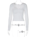 Close-up of white cropped long sleeve top featuring ruched chest detail and scoop neck - S / White