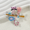 Detail of pink cat enamel brooch with blue fish tank and rhinestone on orange branch - Pink Cat with Fish Tank
