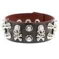 Detail of black PU leather bracelet with silver skull studs and punk metal spikes - Dark Brown Skull