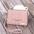 Detailed view of pink fabric wallet with golden heart charm and leather wrist strap - Pink