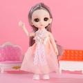 Fashion doll in apricot lace dress with purple-grey hair on a pink sofa background - Kimono Girl