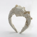 Elegant beige pleated fabric headband with pearl bead embellishments on white background - Off White