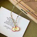 Detail of red apple pendant with colorful braided cord and 65cm length measurement - 3# Necklace - Yellow - Red Apple Slice